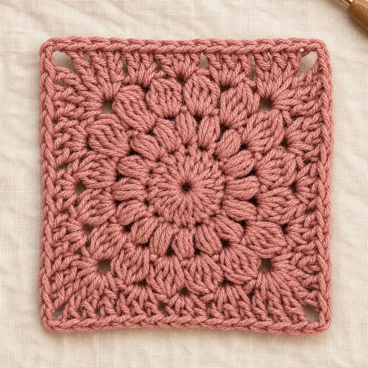 Dusty pink solid-colour sunburst granny square crochet motif